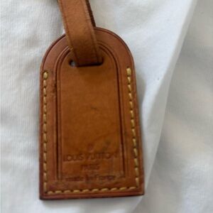 Authentic Louis Vuitton vachetta leather luggage tag.